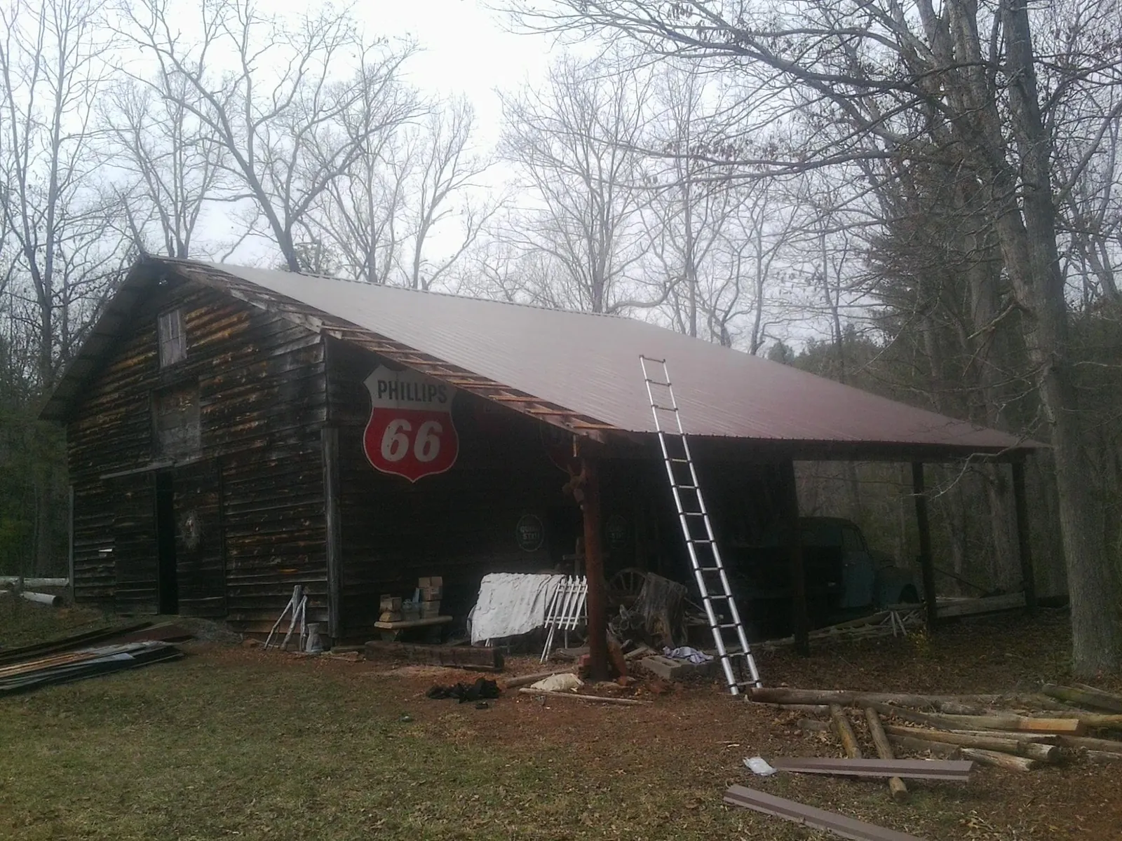 New metal roof on an open sided timber barn with a vintage sign in Cerro Gordo